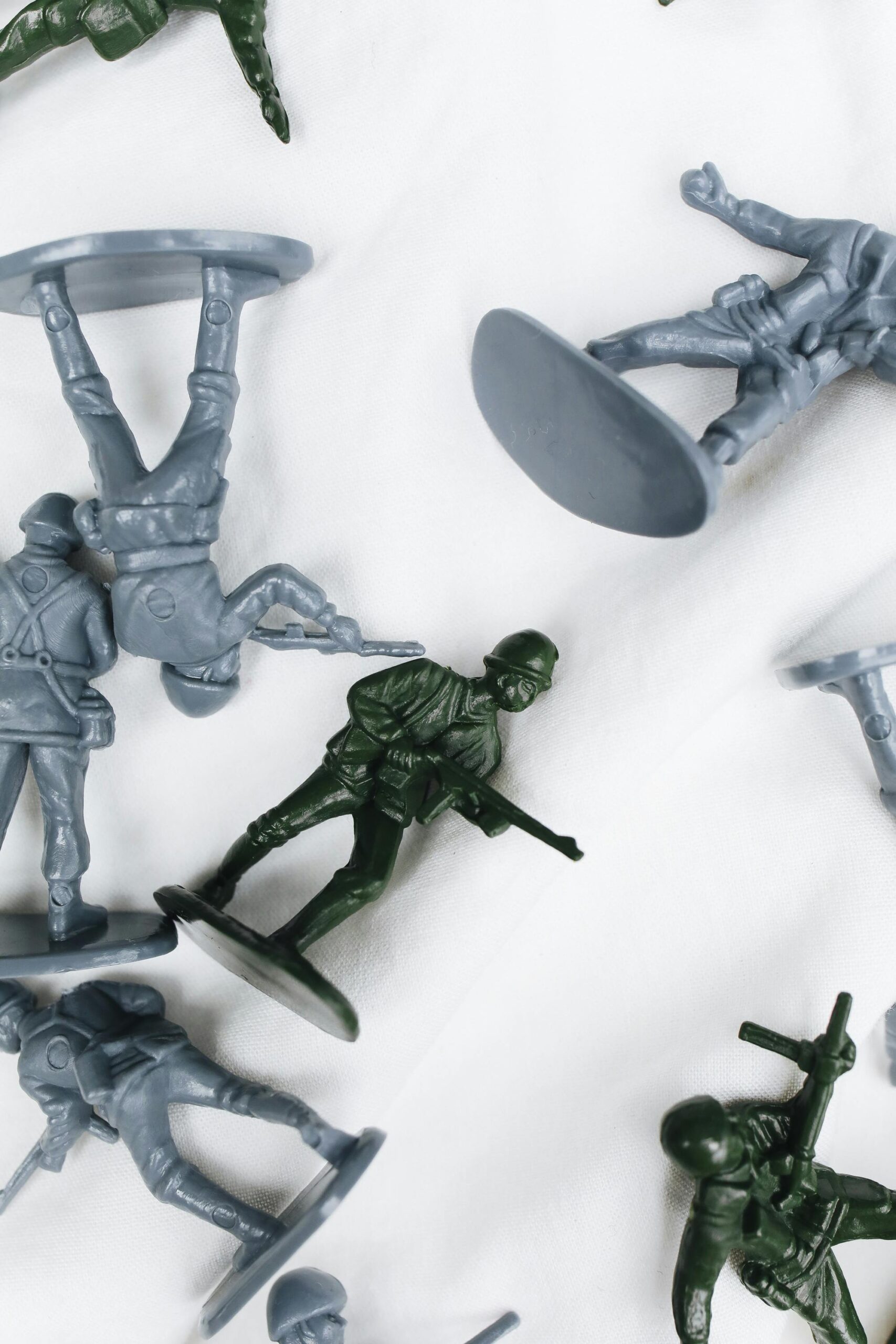 Top view of assorted plastic toy soldiers with varied poses, set against a white background.